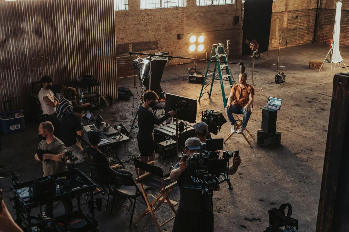 A crew gathered around a camera on set